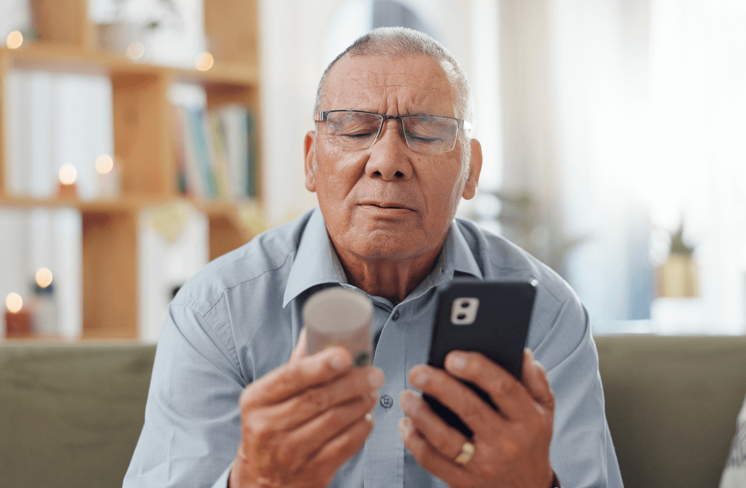 old man looking at multivitamin ingredients