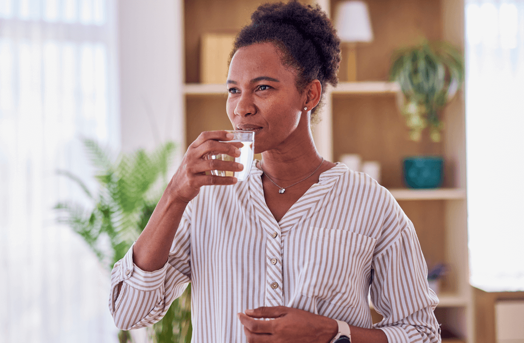 a woman drinking a glass of water
